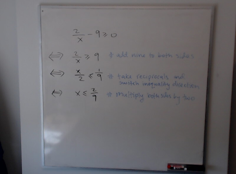 A photo of a whiteboard titled: Solving 2/x - 9 greater than 0