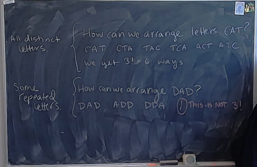 Arranging letters of CAT and DAD A photo of a whiteboard titled: Arranging letters of CAT and DAD