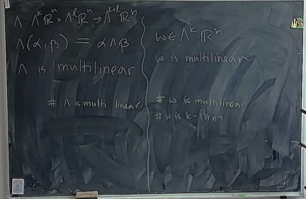 Multilinearity of Wedge versus Forms A photo of a whiteboard titled: Multilinearity of Wedge versus Forms