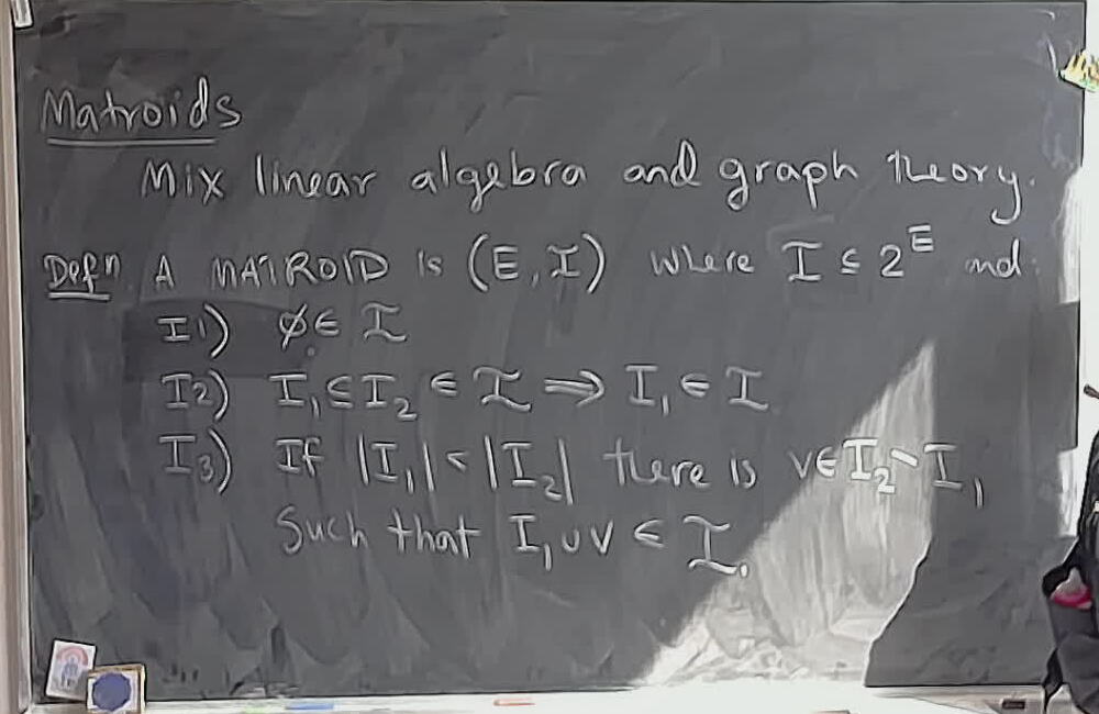 Matroids: Independent Sets Definition A photo of a whiteboard titled: Matroids: Independent Sets Definition